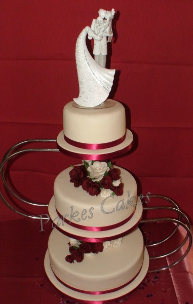 three tier burgundy and ivory wedding cake with handmade sugar rose sprays