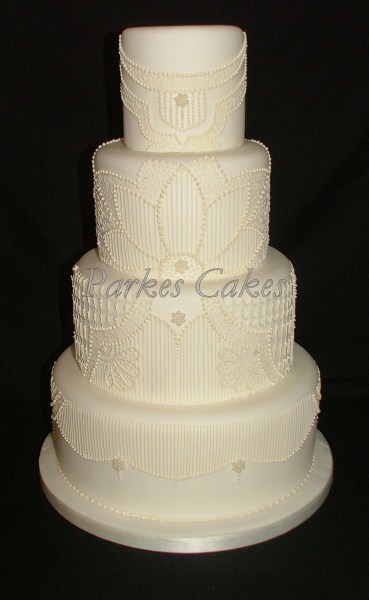 four tier art deco wedding cake with hand piped detail