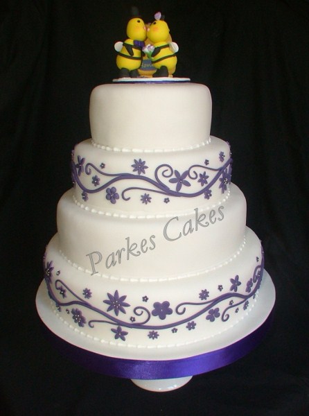 four tier wedding cake with honey pot and bee topper