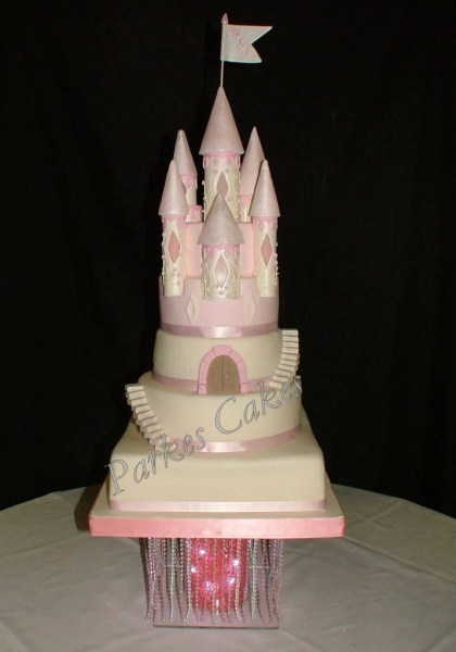 three tier pink and ivory castle wedding cake