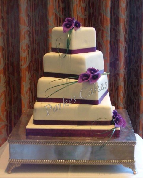 four tier twisted square wedding cake with cala lillies