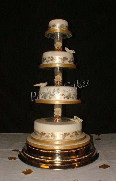 four tier gold wedding cake with royal iced butterflies