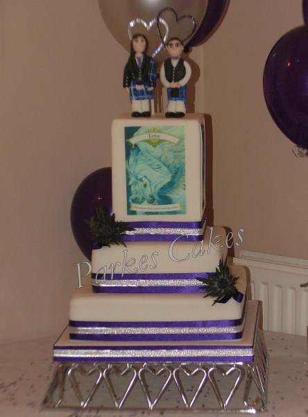 three tier wedding cake with angel cards thistles and handmade civil partnership topper