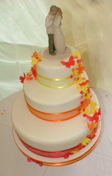 three tier wedding cake with cascading blossoms and butterflies